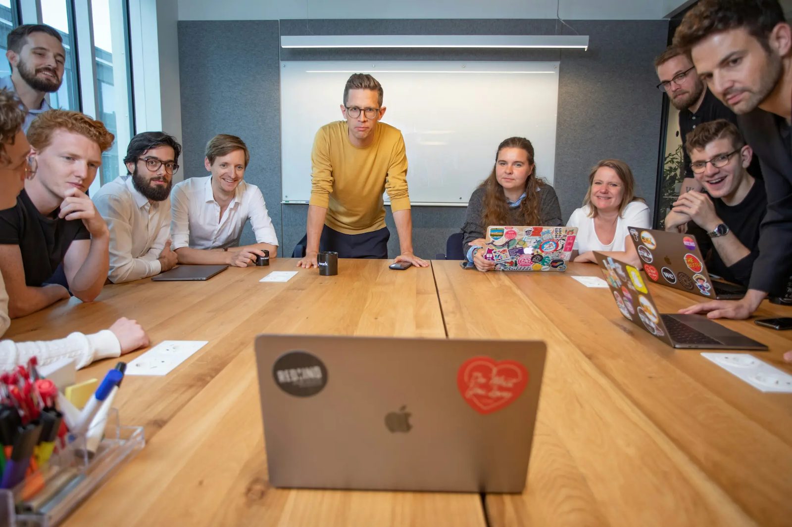 A teaching team gathered around a table with laptops open